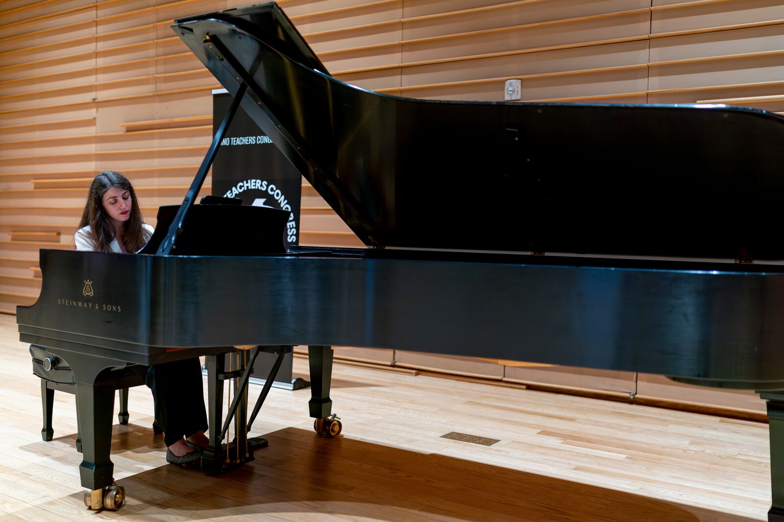 Playing a Steinway grand in a wood-panelled concert hall